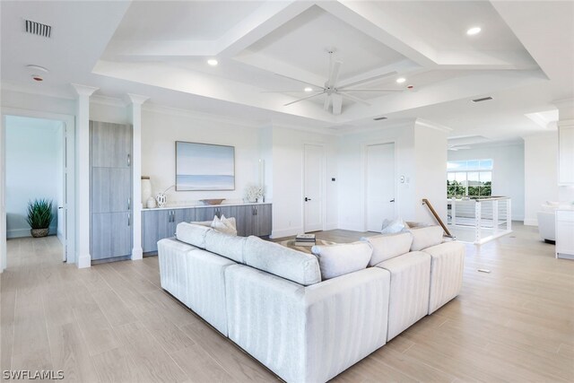 living room featuring ornate columns, coffered ceiling, light wood-type flooring, and ceiling fan