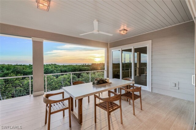 sunroom / solarium featuring wooden ceiling, a healthy amount of sunlight, and ceiling fan