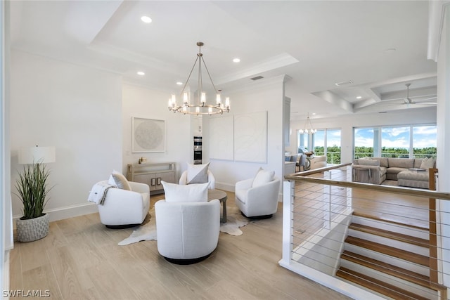 living room featuring light wood-style floors, a tray ceiling, baseboards, and recessed lighting