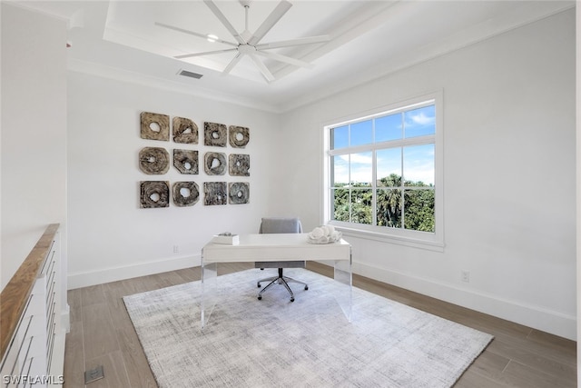 home office with dark wood-type flooring, a raised ceiling, visible vents, and baseboards