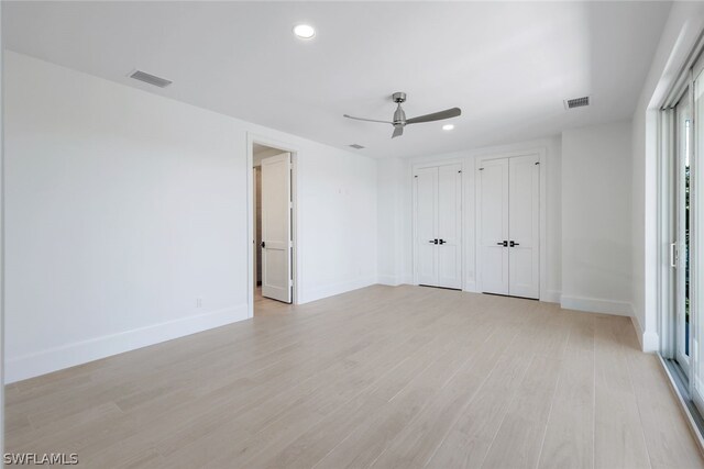 empty room featuring light wood-type flooring and ceiling fan