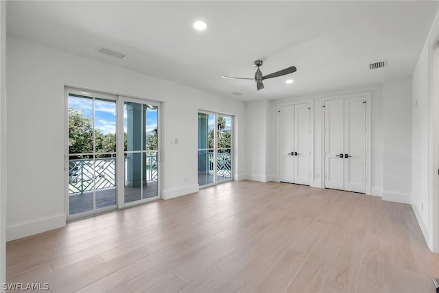 unfurnished room with recessed lighting, visible vents, light wood-style flooring, and baseboards