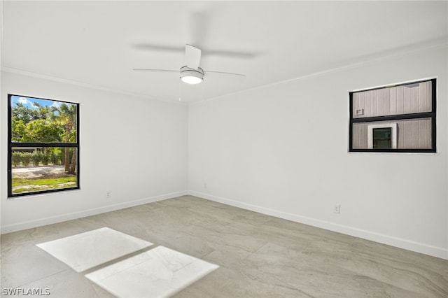 unfurnished room with ceiling fan and ornamental molding