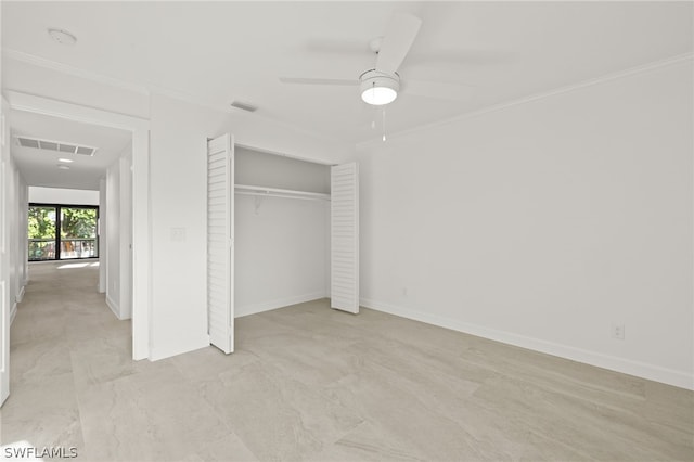 unfurnished bedroom featuring ceiling fan, a closet, and crown molding