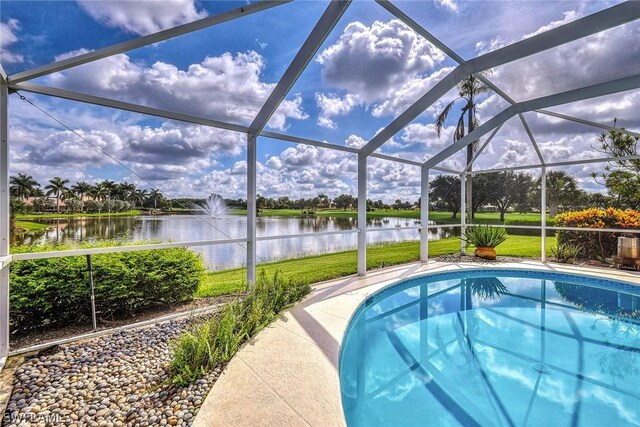 view of swimming pool featuring a lanai and a water view