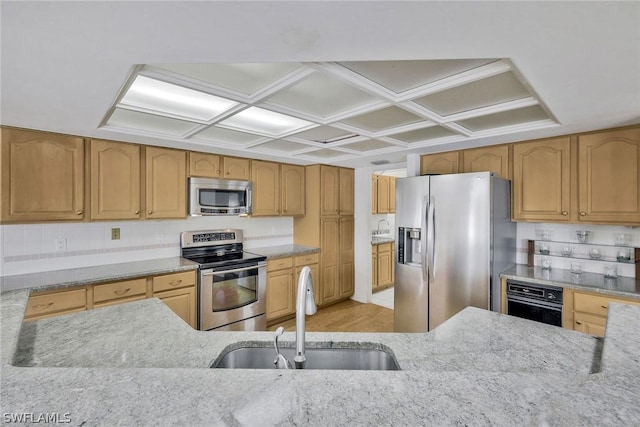 kitchen with light stone countertops, sink, appliances with stainless steel finishes, and tasteful backsplash