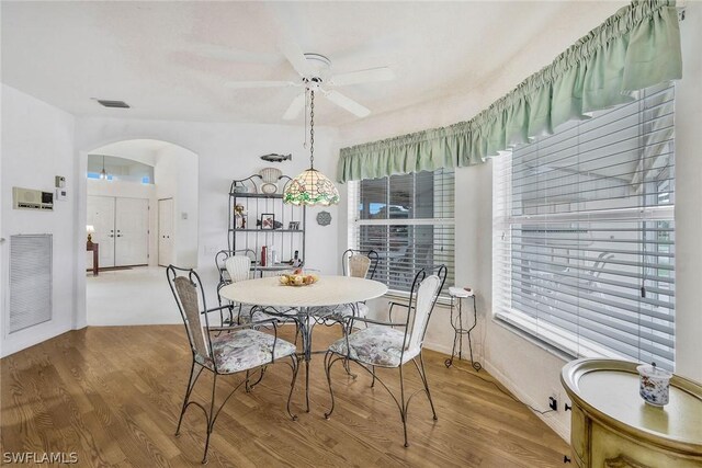 dining room with light hardwood / wood-style floors and ceiling fan