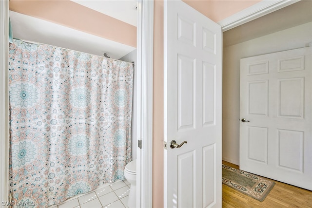 bathroom featuring wood-type flooring and toilet