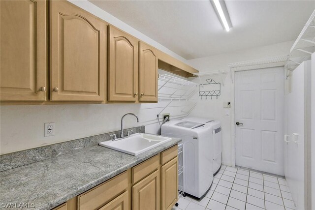 laundry area featuring sink, cabinets, washer and dryer, and light tile patterned floors