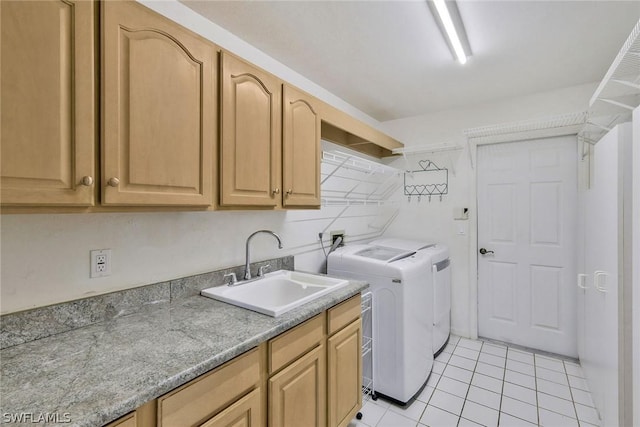 laundry room featuring cabinets, sink, separate washer and dryer, and light tile patterned flooring