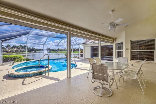 view of swimming pool featuring an in ground hot tub, a water view, a patio area, ceiling fan, and glass enclosure