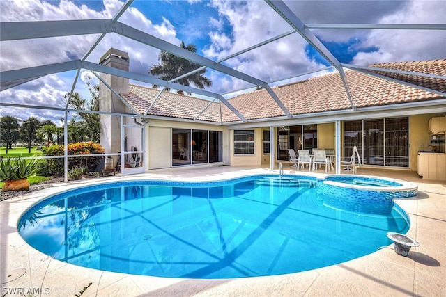 view of pool with glass enclosure and a patio area