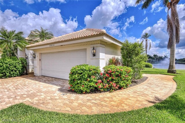 view of property exterior featuring a water view and a garage