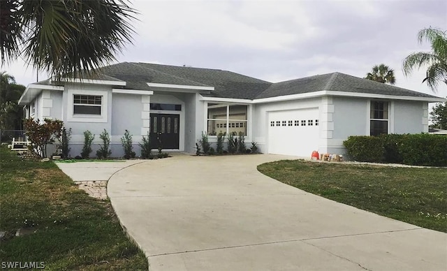 view of front of house featuring an attached garage, a shingled roof, concrete driveway, stucco siding, and a front lawn