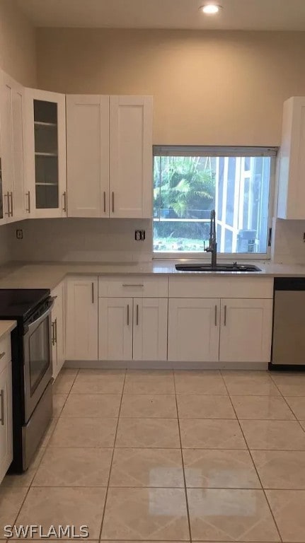 kitchen featuring sink, white cabinetry, a healthy amount of sunlight, and stainless steel appliances