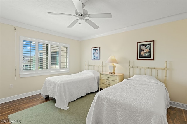 bedroom with ceiling fan, dark hardwood / wood-style flooring, and crown molding