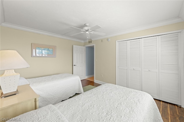 bedroom featuring ceiling fan, a closet, dark hardwood / wood-style floors, and ornamental molding