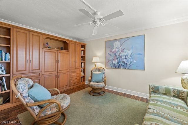 living area with crown molding, ceiling fan, and dark wood-type flooring