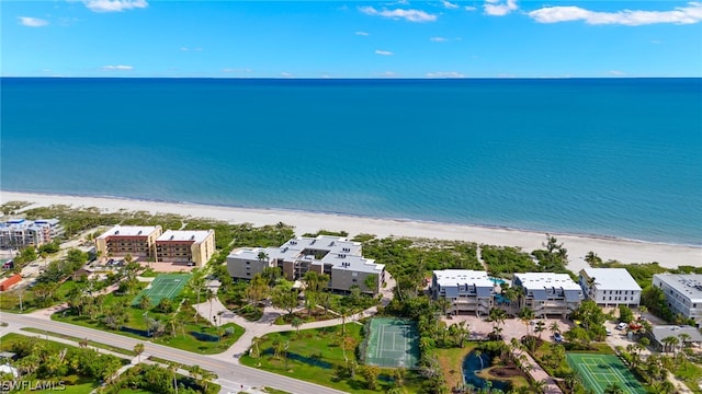 birds eye view of property with a beach view and a water view