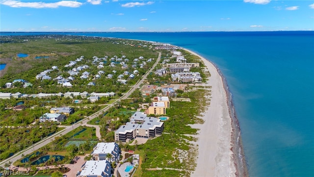 drone / aerial view featuring a water view and a beach view