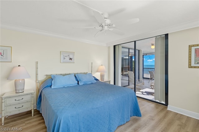 bedroom with access to exterior, expansive windows, ceiling fan, crown molding, and light hardwood / wood-style flooring