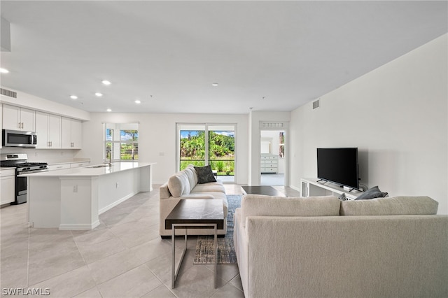 living room featuring light tile patterned flooring and sink