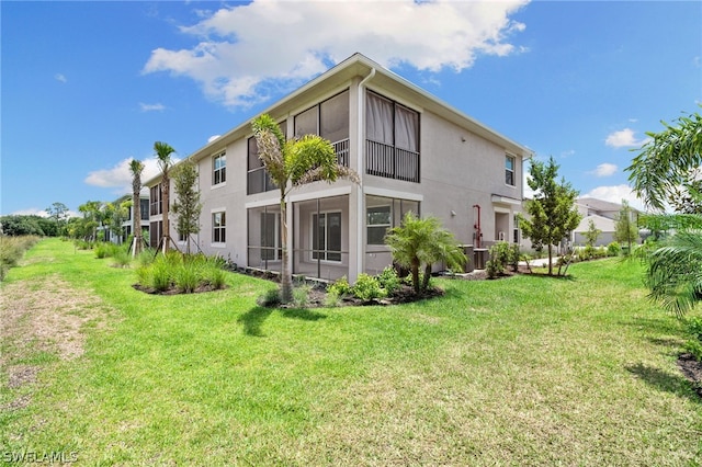 rear view of property with a yard