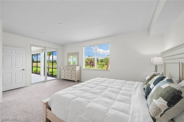 carpeted bedroom featuring access to outside