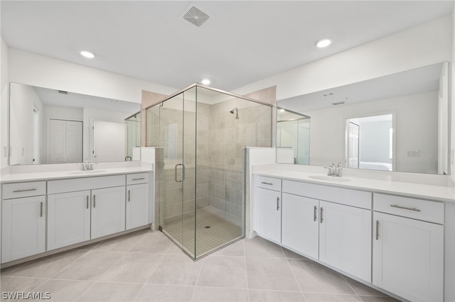 bathroom featuring vanity, tile patterned floors, and a shower with shower door