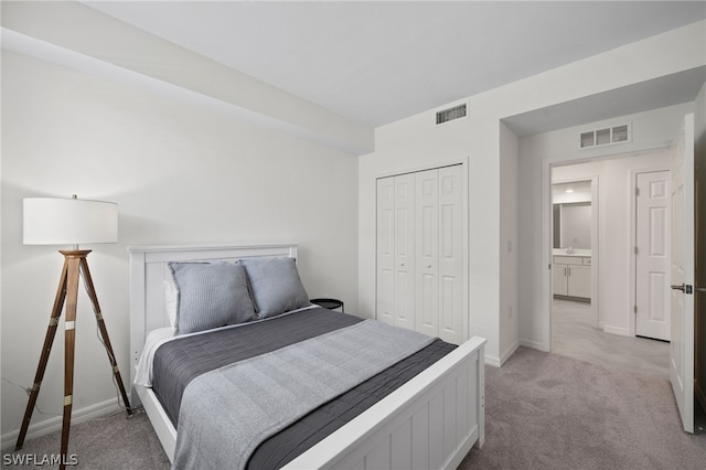 bedroom with light colored carpet and a closet