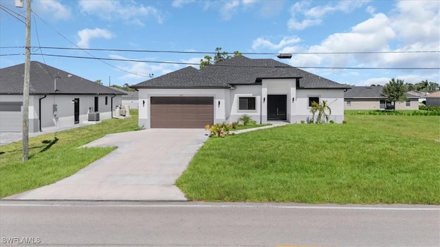 view of front of home with a garage and a front lawn