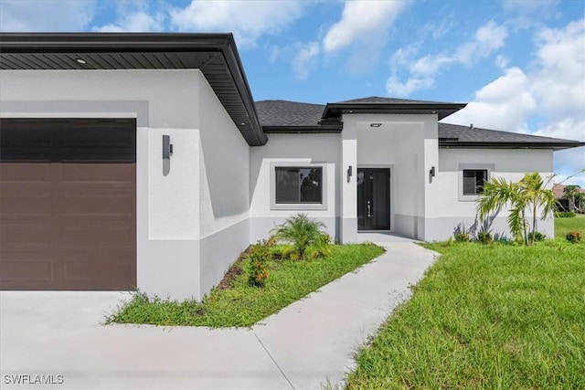 817 Jacaranda Pkwy E, Cape Coral, FL 33909 - view of front facade with a garage, a front lawn, stucco siding, and a shingled roof