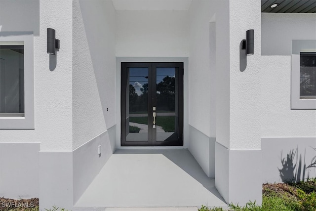 view of exterior entry featuring french doors