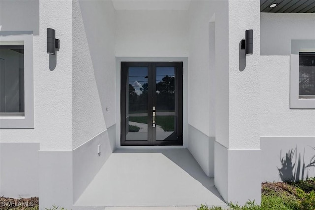 817 Jacaranda Pkwy E, Cape Coral, FL 33909 - property entrance featuring french doors and stucco siding