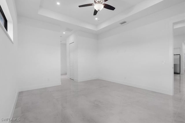 unfurnished room featuring a tray ceiling and ceiling fan