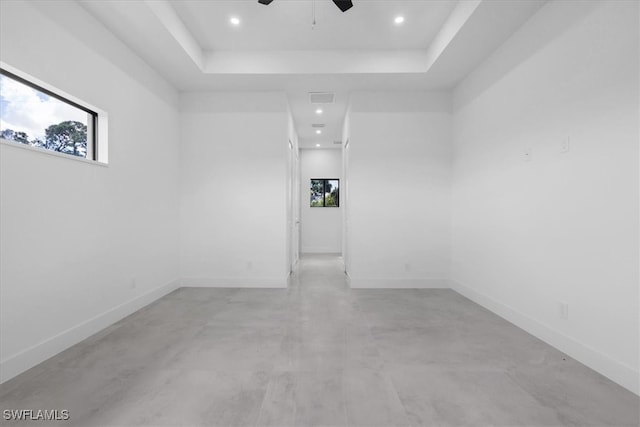 spare room featuring ceiling fan and a tray ceiling