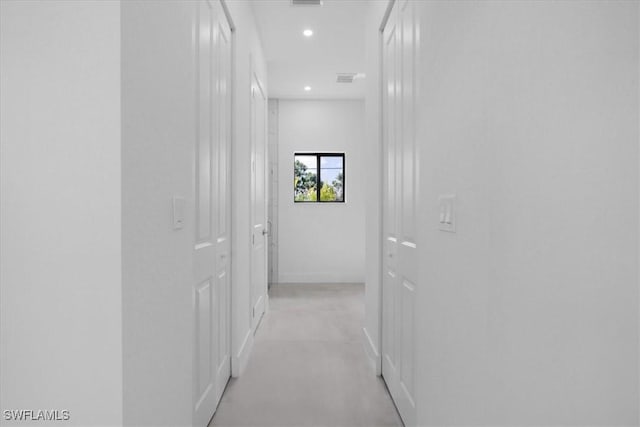 817 Jacaranda Pkwy E, Cape Coral, FL 33909 - hall featuring finished concrete flooring, baseboards, recessed lighting, and visible vents