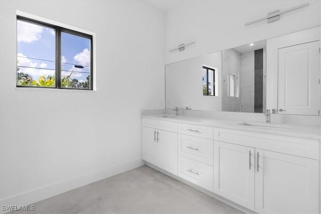 817 Jacaranda Pkwy E, Cape Coral, FL 33909 - full bath featuring double vanity, concrete flooring, baseboards, a sink, and a stall shower