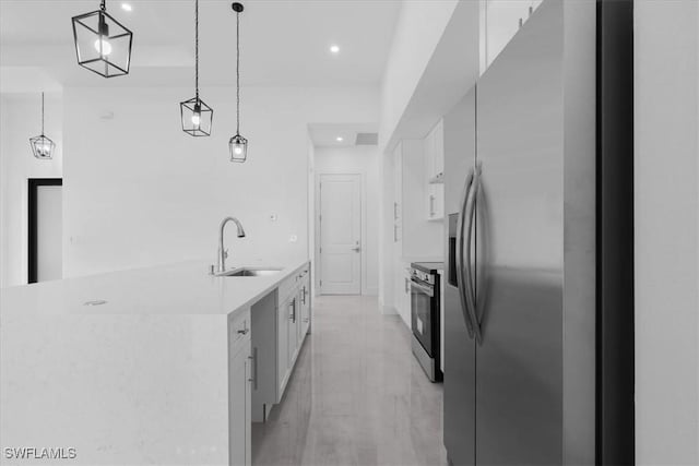 817 Jacaranda Pkwy E, Cape Coral, FL 33909 - kitchen with a sink, light countertops, stainless steel appliances, decorative light fixtures, and white cabinetry
