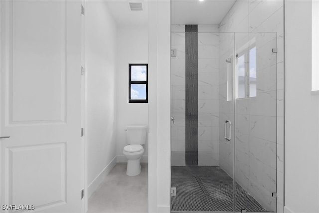 bathroom with walk in shower and toilet