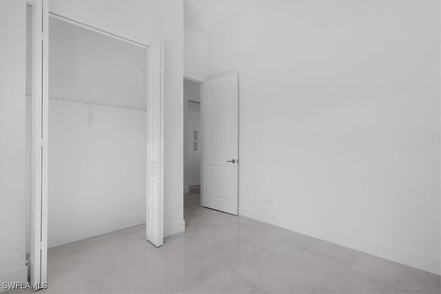 817 Jacaranda Pkwy E, Cape Coral, FL 33909 - unfurnished bedroom featuring concrete floors and a closet