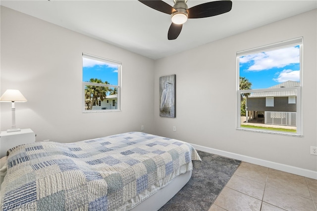 bedroom with ceiling fan and light tile patterned flooring