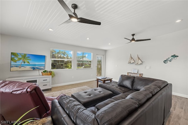 living room featuring ceiling fan and light hardwood / wood-style floors