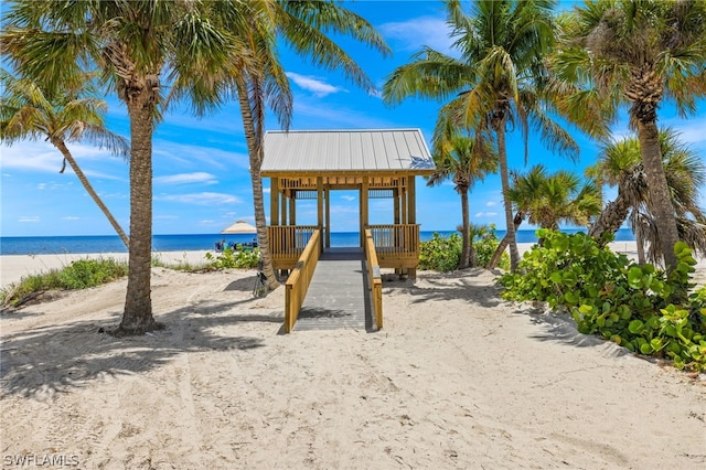 view of play area with a water view and a view of the beach