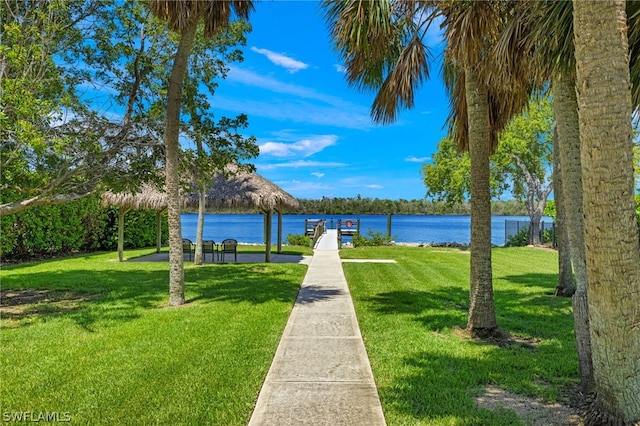 view of property's community featuring a water view and a lawn