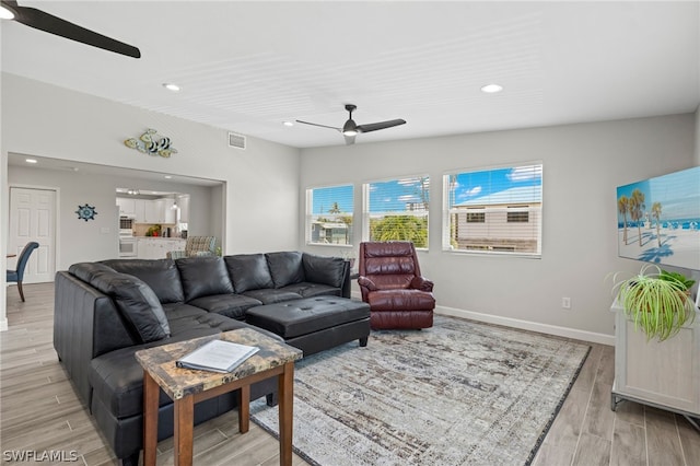 living room featuring ceiling fan and light wood-type flooring