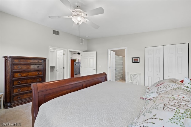 tiled bedroom with ensuite bathroom, a closet, and ceiling fan