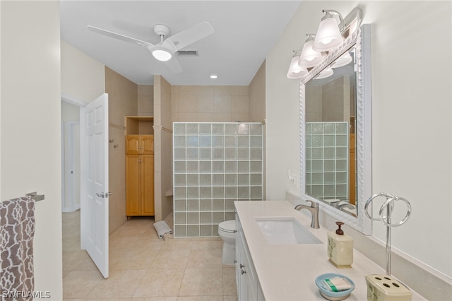 bathroom with tile patterned floors, ceiling fan, toilet, and vanity