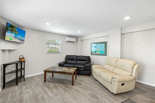 living room with hardwood / wood-style floors and a wall mounted air conditioner