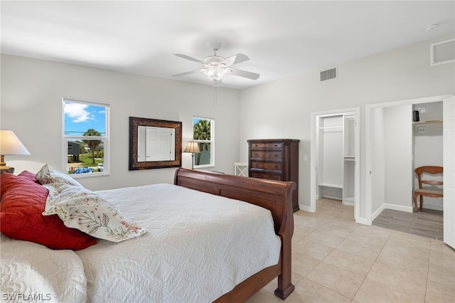 bedroom featuring a walk in closet, ceiling fan, and a closet